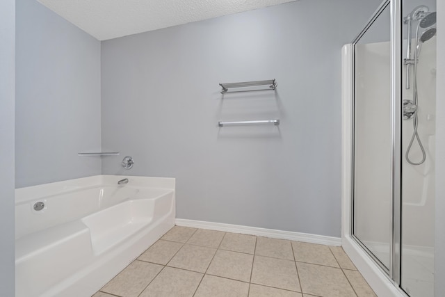 bathroom featuring tile patterned flooring, a textured ceiling, and shower with separate bathtub