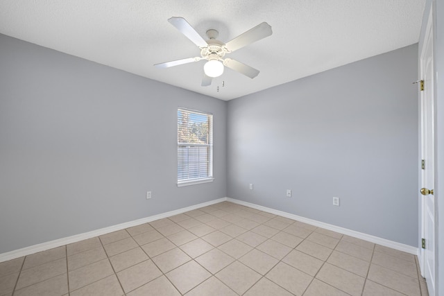 unfurnished room with ceiling fan and light tile patterned floors