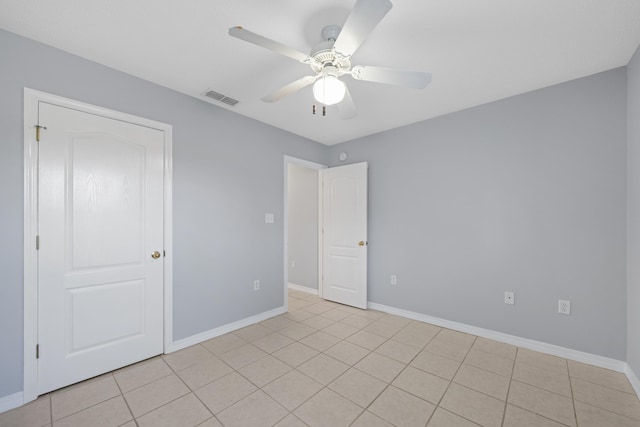 spare room featuring light tile patterned floors and ceiling fan