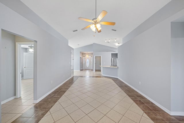 unfurnished living room with dark tile patterned flooring, ceiling fan, and lofted ceiling