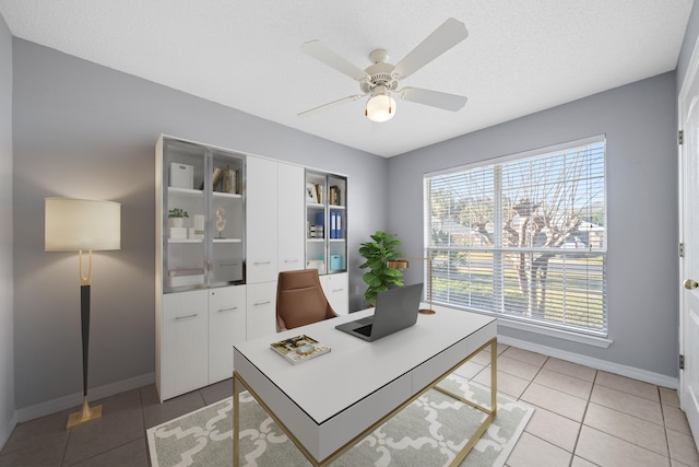 home office with ceiling fan, tile patterned flooring, and a textured ceiling