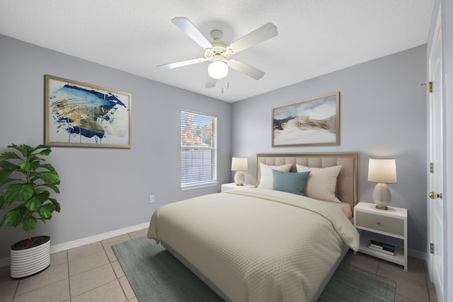 bedroom with ceiling fan and light tile patterned floors