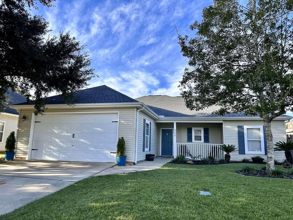 single story home featuring a front yard, a porch, and a garage