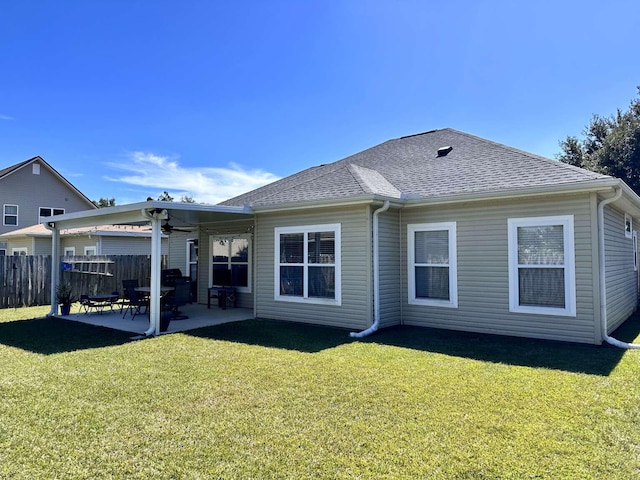 back of property featuring a patio area and a yard