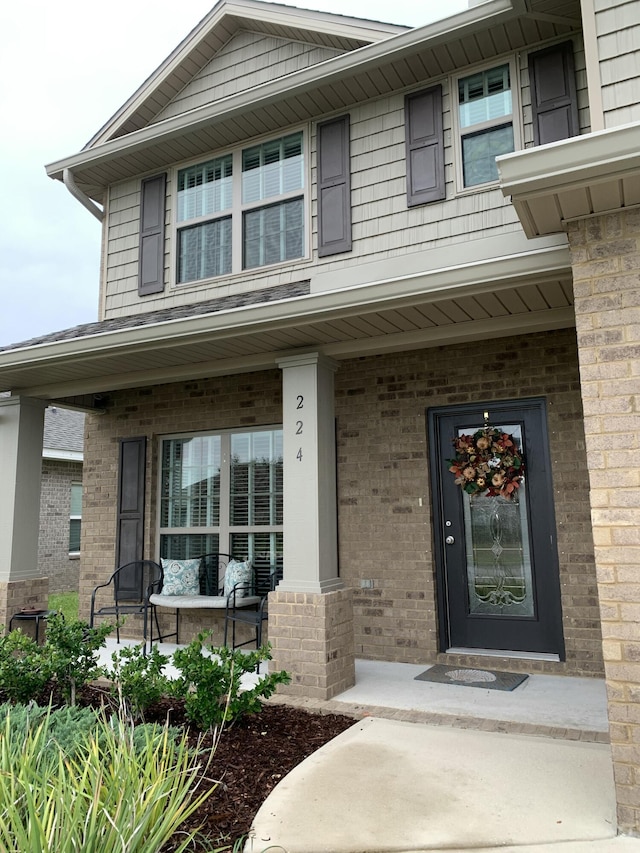 view of exterior entry featuring a porch