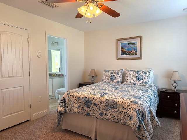 bedroom featuring ceiling fan, ensuite bathroom, and carpet flooring