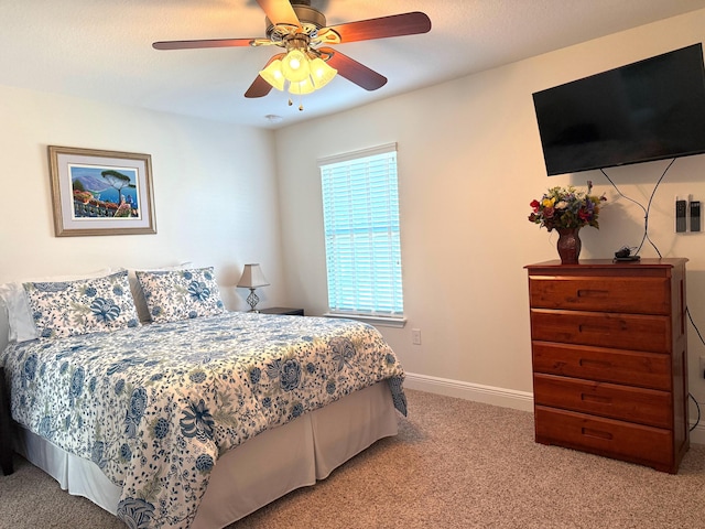 bedroom with ceiling fan and light carpet