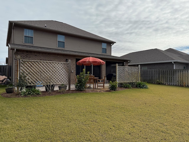 back of property featuring a lawn and a patio