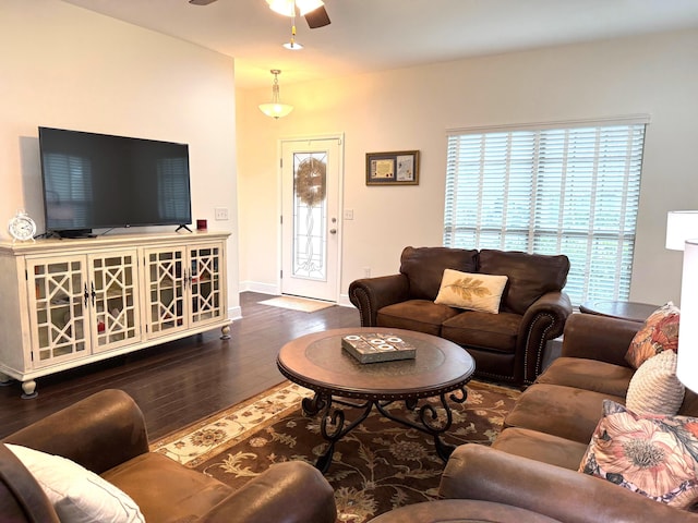 living room with dark wood-type flooring and ceiling fan