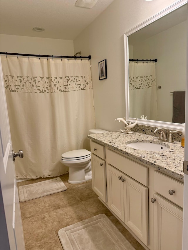 bathroom with toilet and vanity