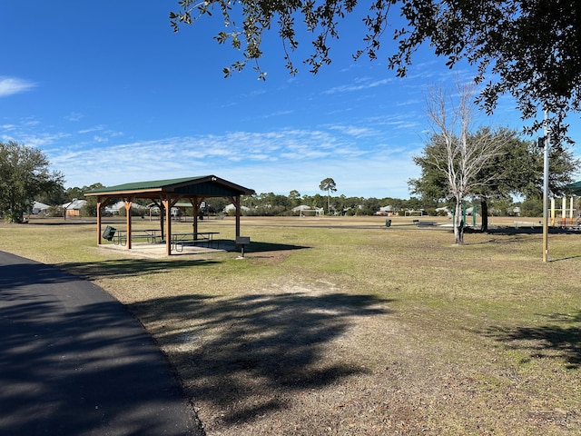 surrounding community with a gazebo and a yard