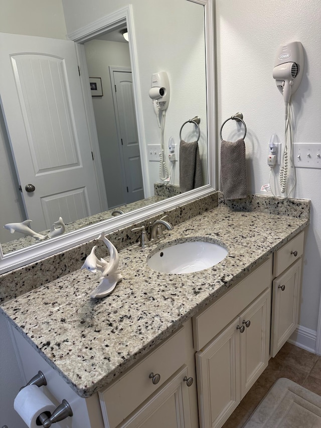 bathroom with tile patterned floors and vanity