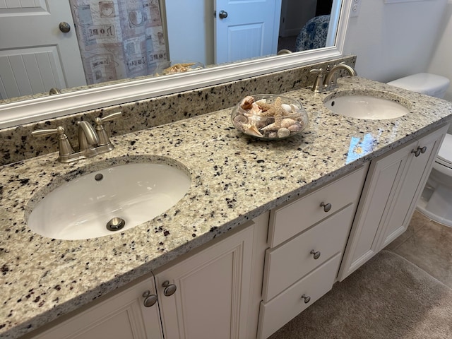 bathroom featuring toilet and vanity