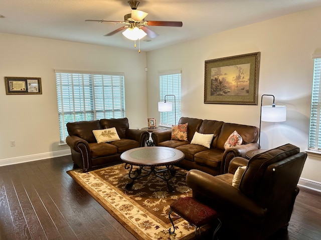 living room with ceiling fan and dark hardwood / wood-style flooring