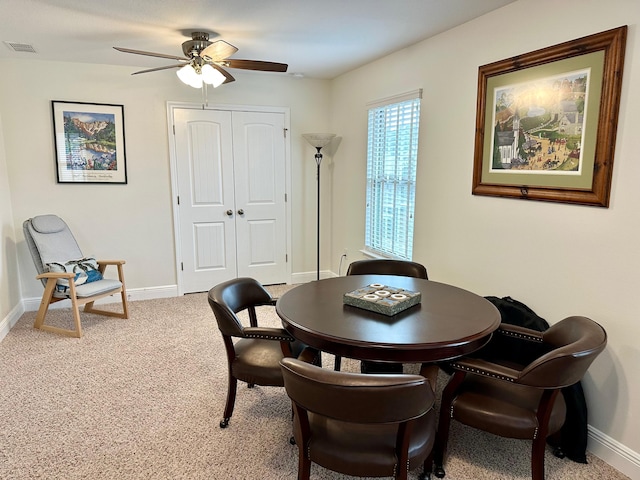 carpeted dining area featuring ceiling fan