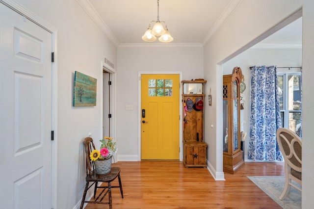 foyer entrance with crown molding and light hardwood / wood-style flooring