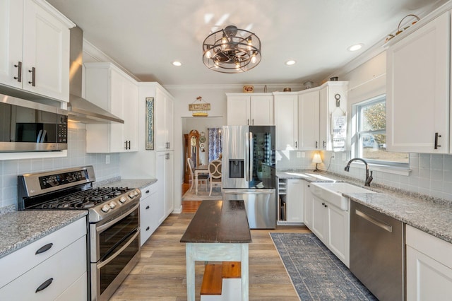 kitchen featuring light stone counters, sink, white cabinets, and stainless steel appliances