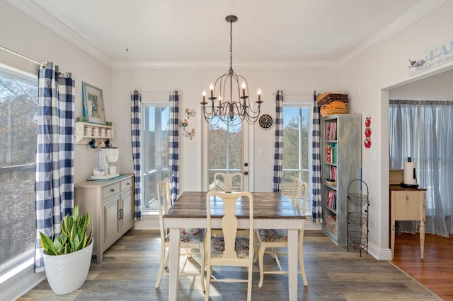 dining room with a chandelier, hardwood / wood-style floors, and ornamental molding