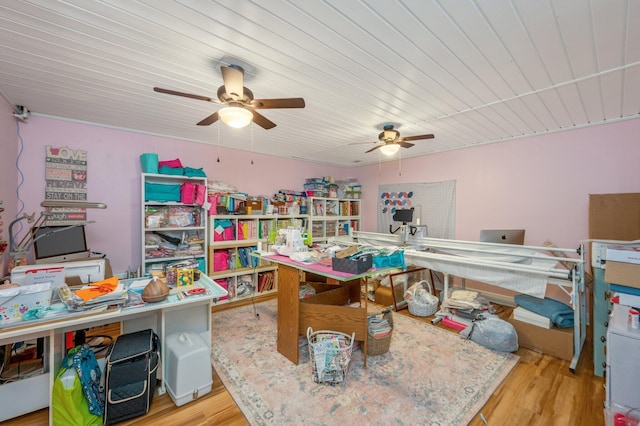 recreation room with ceiling fan, light wood-type flooring, and wood ceiling