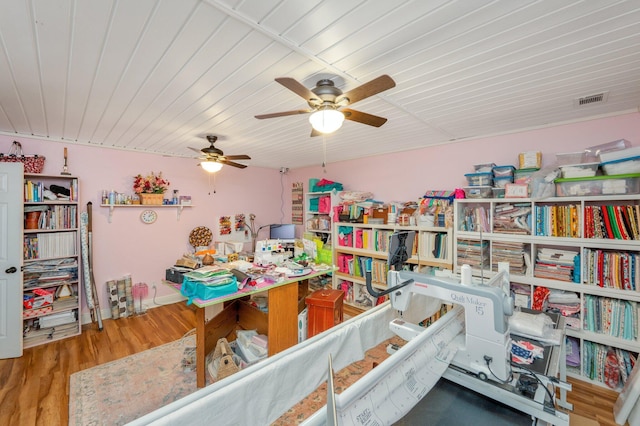 recreation room featuring ceiling fan and hardwood / wood-style floors