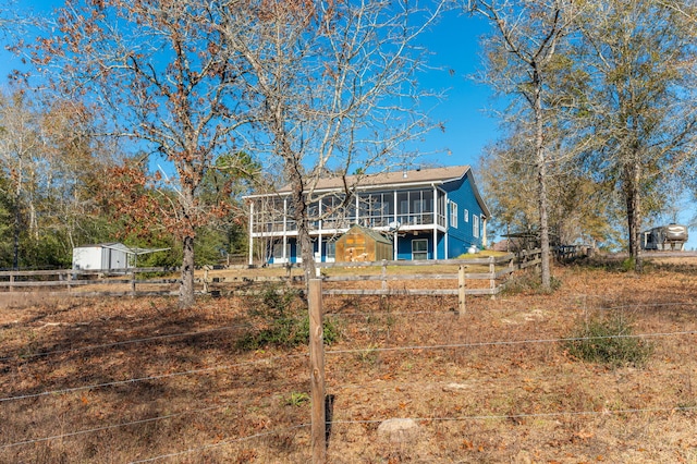 rear view of property with a wooden deck and a sunroom