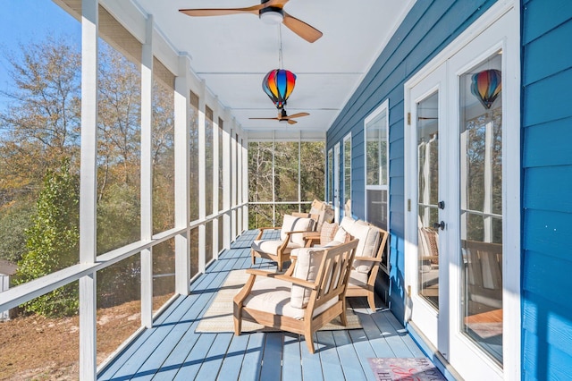 unfurnished sunroom featuring ceiling fan