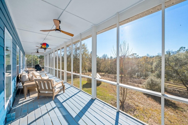 sunroom featuring ceiling fan