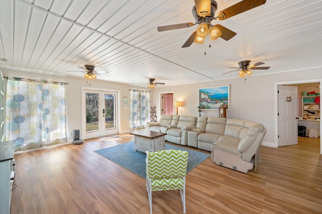 living room featuring french doors, light hardwood / wood-style flooring, and wooden ceiling