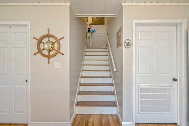 stairway with hardwood / wood-style floors