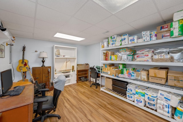 office featuring a paneled ceiling and light wood-type flooring