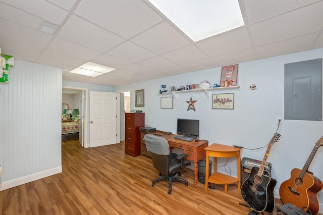 office featuring electric panel, a paneled ceiling, and light wood-type flooring