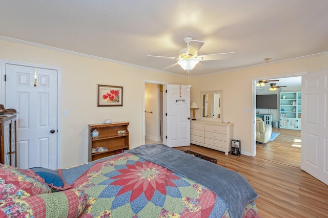 bedroom with ceiling fan, wood-type flooring, ornamental molding, and a closet