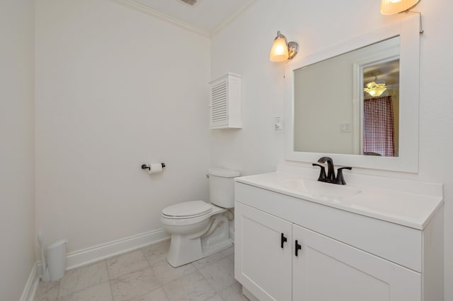 bathroom with vanity, toilet, and crown molding