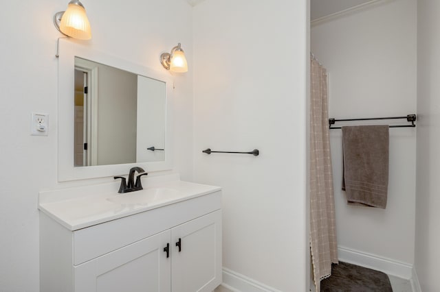 bathroom with vanity and ornamental molding