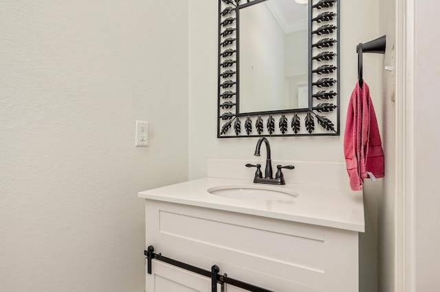 bathroom featuring crown molding and vanity