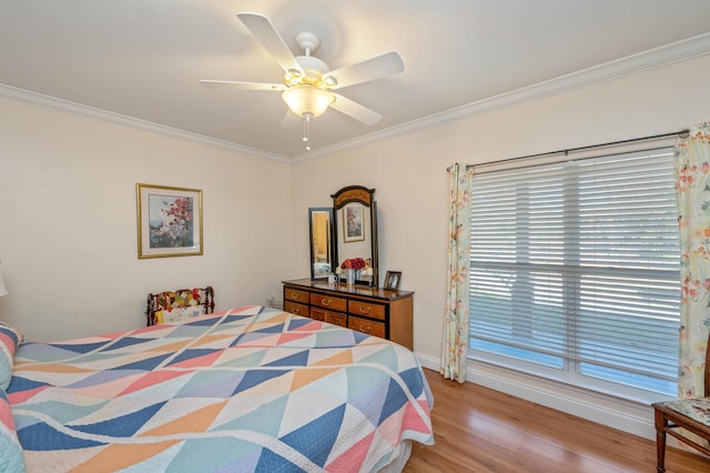 bedroom featuring light hardwood / wood-style flooring, ceiling fan, and ornamental molding