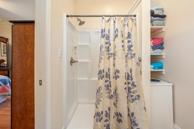 bathroom featuring hardwood / wood-style flooring, curtained shower, and crown molding