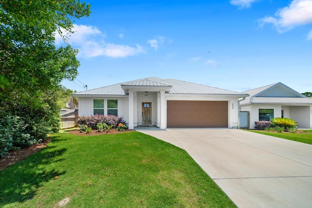 view of front of home featuring a front yard and a garage