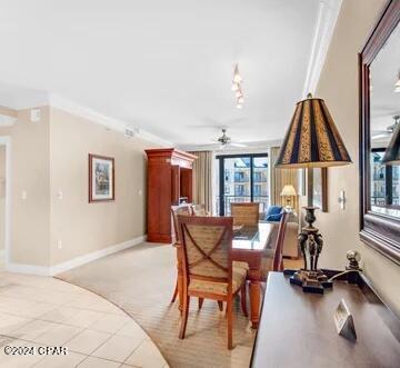 carpeted dining area featuring ceiling fan and ornamental molding