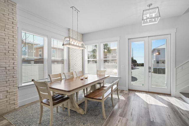 dining room featuring hardwood / wood-style flooring and an inviting chandelier