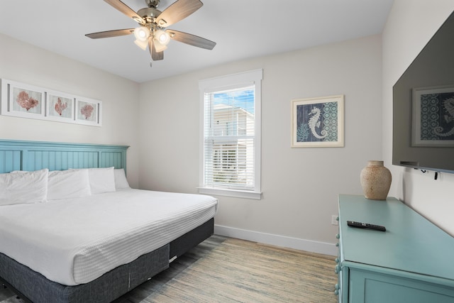 bedroom with ceiling fan and hardwood / wood-style flooring