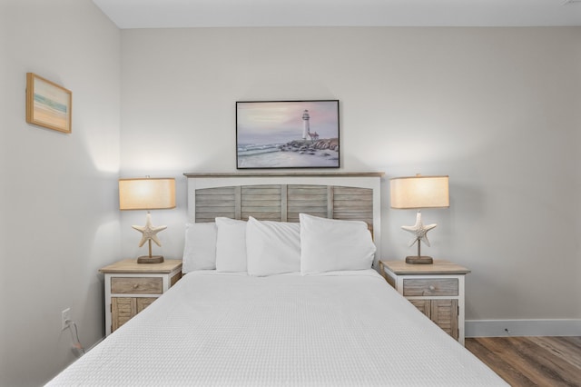 bedroom with dark hardwood / wood-style flooring