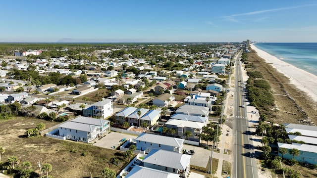 drone / aerial view with a beach view and a water view