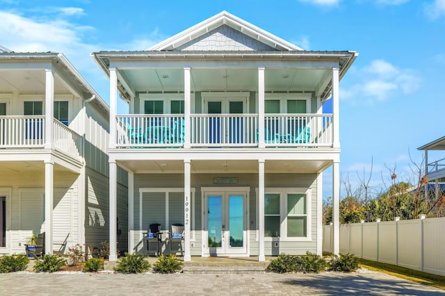 view of front of property featuring a balcony and french doors