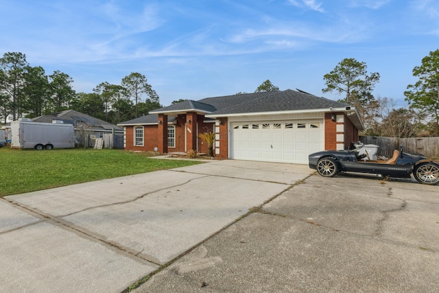 ranch-style home featuring a garage and a front lawn