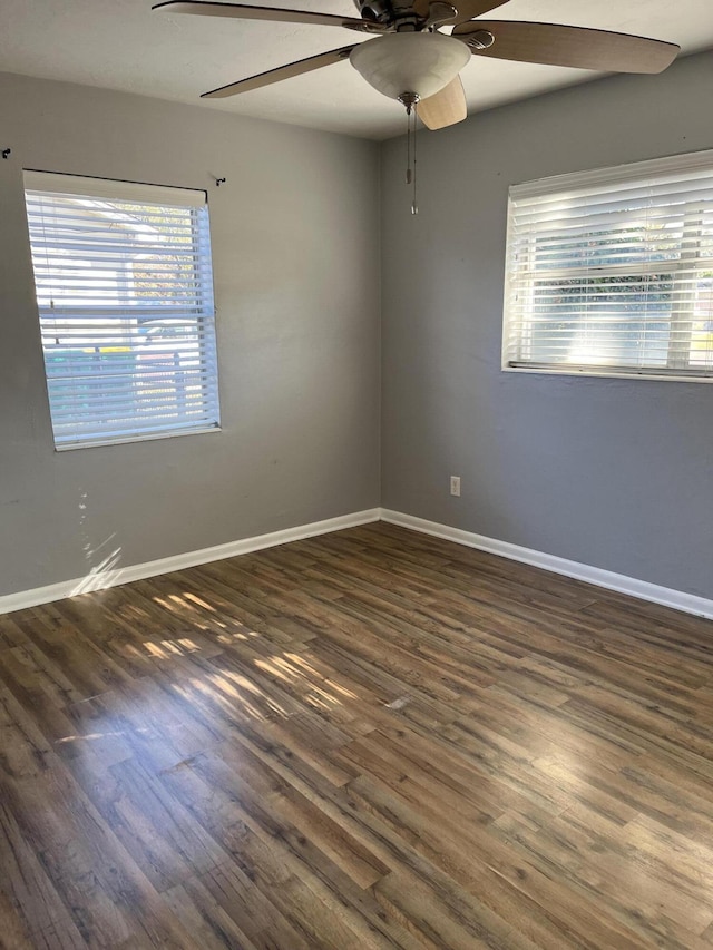 unfurnished room with ceiling fan and dark hardwood / wood-style flooring