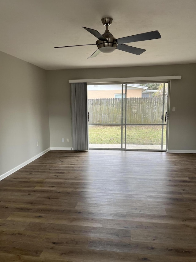 unfurnished room featuring ceiling fan and dark wood-type flooring