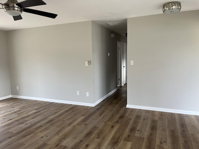 unfurnished room featuring ceiling fan and dark wood-type flooring