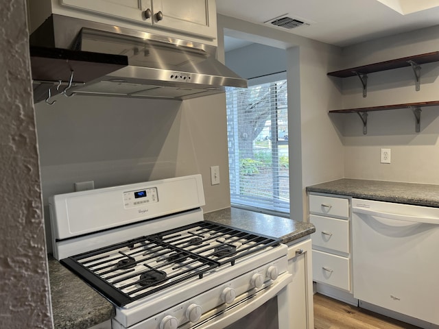 kitchen featuring white appliances, white cabinets, light hardwood / wood-style flooring, and island range hood