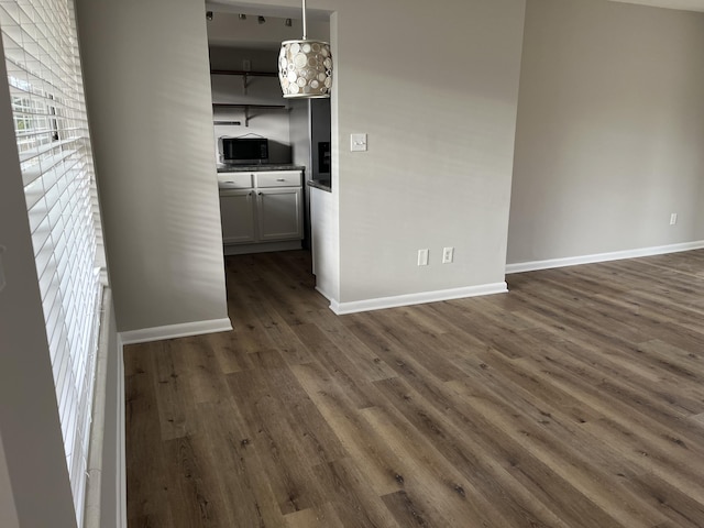 spare room with dark hardwood / wood-style flooring